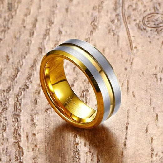 Gold and silver ring on a wooden surface